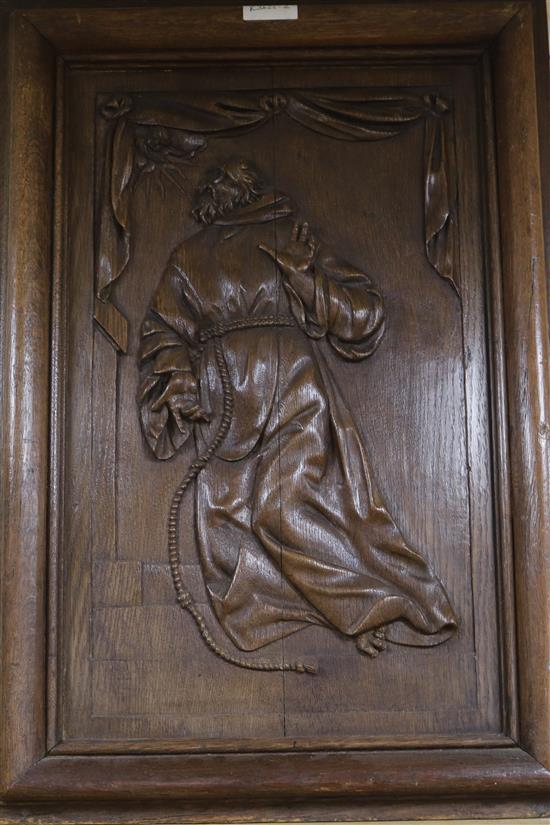 A 19th century French oak panel carved St Francis of Assiss, ex Chateau Champfleur